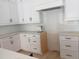 Bright kitchen features white cabinets, drawers, grey countertops, black hardware, and subway tile backsplash at 002 White St # 2, Marietta, GA 30060