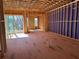 Spacious living room under construction with exposed wood framing, sliding glass door, and natural light at 002 White St # 2, Marietta, GA 30060