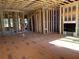 Spacious living room under construction with fireplace, exposed wood framing, and natural light at 002 White St # 2, Marietta, GA 30060