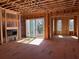 Bright living room under construction featuring a fireplace, sliding glass doors, and exposed wood framing at 002 White St # 2, Marietta, GA 30060