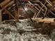 View of the attic space with exposed beams and insulation material at 1416 Mcpherson Se Ave, Atlanta, GA 30316