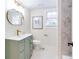 Charming bathroom featuring a green vanity and round gold mirror at 1416 Mcpherson Se Ave, Atlanta, GA 30316