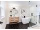 Beautiful bathroom featuring a modern vanity, standalone tub, black hardware, and walk-in shower at 1416 Mcpherson Se Ave, Atlanta, GA 30316