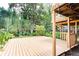 Ground level wooden deck area with a pergola features lush surrounding landscape at 1416 Mcpherson Se Ave, Atlanta, GA 30316