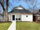 Charming bungalow with a crisp white exterior, black star detail, and a welcoming walkway at 1416 Mcpherson Se Ave, Atlanta, GA 30316