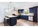 Bright kitchen featuring modern appliances, stylish navy cabinetry, and bar seating at 1416 Mcpherson Se Ave, Atlanta, GA 30316