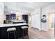 Well-lit kitchen featuring stylish bar seating, navy cabinets, and stainless steel appliances at 1416 Mcpherson Se Ave, Atlanta, GA 30316