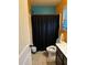 Traditional bathroom with a shower behind a black curtain and a white toilet, blending functionality with classic style at 150 Bellemeade Ct, Fayetteville, GA 30215