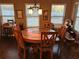 Cozy dining room featuring a round wood table, six chairs, and natural light from the surrounding windows at 150 Bellemeade Ct, Fayetteville, GA 30215