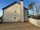 View of the home's exterior, highlighting the chimney and siding, complete with a fenced backyard for added privacy at 150 Bellemeade Ct, Fayetteville, GA 30215