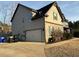 Two-story home with stone accents, siding, and an attached garage at 150 Bellemeade Ct, Fayetteville, GA 30215