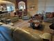 Comfortable living room featuring plush seating, neutral carpet, a decorative coffee table, and natural light at 150 Bellemeade Ct, Fayetteville, GA 30215