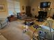 Inviting living room space with carpet, a decorative fireplace, comfortable seating, and exercise equipment at 150 Bellemeade Ct, Fayetteville, GA 30215