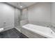 Modern bathroom features a glass enclosed shower, a separate soaking tub, and grey tile at 1820 Peachtree Nw St # 1207, Atlanta, GA 30309