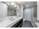 Contemporary bathroom with dual sinks, modern fixtures, and a glass-enclosed shower at 1820 Peachtree Nw St # 1207, Atlanta, GA 30309