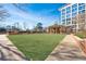 Exterior grounds featuring a lush green lawn in front of a condominium building at 1820 Peachtree Nw St # 1207, Atlanta, GA 30309