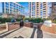 Outdoor grilling area featuring built-in grills with brick accents and a lush green backdrop at 1820 Peachtree Nw St # 1207, Atlanta, GA 30309