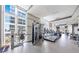 Spacious gym with floor-to-ceiling windows and multiple treadmills and weight machines at 1820 Peachtree Nw St # 1207, Atlanta, GA 30309