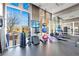 Bright fitness center with floor to ceiling windows, a mirror wall, and cardio and weight equipment at 1820 Peachtree Nw St # 1207, Atlanta, GA 30309