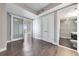 Well-lit hallway with hardwood floors and a clear view into the bathroom at 1820 Peachtree Nw St # 1207, Atlanta, GA 30309