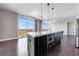 Bright, modern kitchen with dark wood floors, island, granite counters, and stainless steel refrigerator at 1820 Peachtree Nw St # 1207, Atlanta, GA 30309