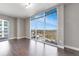 Bright living room with hardwood floors and floor-to-ceiling windows offering panoramic views at 1820 Peachtree Nw St # 1207, Atlanta, GA 30309