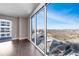 Living room featuring dark hardwood floors and a large window with a city view at 1820 Peachtree Nw St # 1207, Atlanta, GA 30309