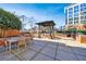 Outdoor dining and grilling area with a pergola and views of a building complex at 1820 Peachtree Nw St # 1207, Atlanta, GA 30309