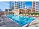 Beautiful outdoor pool with lounge chairs and clear blue water, surrounded by upscale buildings at 1820 Peachtree Nw St # 1207, Atlanta, GA 30309
