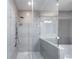 Contemporary shower with glass enclosure, multiple shower heads and grey tile at 1820 Peachtree Nw St # 1207, Atlanta, GA 30309