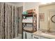 Bathroom featuring a shower with curtain and open shelving for practical storage and functionality at 223 Misty View Dr, Canton, GA 30114