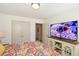 Bedroom showcasing a colorfully patterned bedspread and modern media center with a large screen television at 223 Misty View Dr, Canton, GA 30114