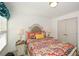 Comfortable bedroom offers a colorfully patterned bedspread and a pair of bedside tables with lamps at 223 Misty View Dr, Canton, GA 30114