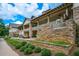 Multi-story building with stone accents, outdoor seating areas, and landscaped grounds at 223 Misty View Dr, Canton, GA 30114