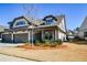 Charming home exterior, with a two-car garage, inviting entrance, and manicured lawn at 223 Misty View Dr, Canton, GA 30114