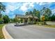 A quaint guard house at the entrance to the community with well maintained landscaping and a security gate at 223 Misty View Dr, Canton, GA 30114