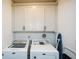 Laundry room features a washer, dryer, and white cabinets for storage at 223 Misty View Dr, Canton, GA 30114