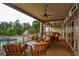 Covered patio with comfortable seating, a ceiling fan, and a view of the pool and trees at 223 Misty View Dr, Canton, GA 30114