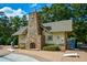 Poolside lounging area with charming stone fireplace and seating at 223 Misty View Dr, Canton, GA 30114