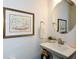 Stylish powder room with a pedestal sink, round mirror, and charming decor at 223 Misty View Dr, Canton, GA 30114