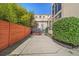Backyard area featuring a concrete patio, privacy fence, mature foliage, and exterior building view for outdoor enjoyment at 307 Cherokee Se Ave # 9, Atlanta, GA 30312