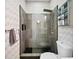 Updated bathroom featuring gray stone tile and glass shower with matte black fixtures at 307 Cherokee Se Ave # 9, Atlanta, GA 30312