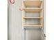 An open closet featuring neutral shelving, hanging bar, and red hooks on the wall for functional storage solutions at 307 Cherokee Se Ave # 9, Atlanta, GA 30312