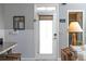 Bright entryway featuring a frosted glass door, half wall trim, and view into a closet with decoratively lit shelves at 307 Cherokee Se Ave # 9, Atlanta, GA 30312