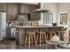 Kitchen island with cooktop, stainless appliances, stone backsplash, and modern cabinetry at 307 Cherokee Se Ave # 9, Atlanta, GA 30312