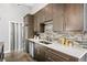 Modern kitchen with stainless steel appliances, stone backsplash, and pantry door at 307 Cherokee Se Ave # 9, Atlanta, GA 30312