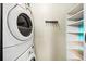 Efficient laundry room with a stacked washer and dryer, plus custom shelving at 307 Cherokee Se Ave # 9, Atlanta, GA 30312