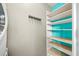 Functional laundry area featuring shelving with a pop of color, hanging rack, and modern washer and dryer at 307 Cherokee Se Ave # 9, Atlanta, GA 30312