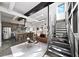 Open-concept living space with exposed ductwork, a modern kitchen, and a striking metal staircase at 307 Cherokee Se Ave # 9, Atlanta, GA 30312