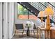 Stylish seating area with wood frame chairs and lamps, set beneath metal stairs leading to the upper level at 307 Cherokee Se Ave # 9, Atlanta, GA 30312